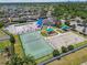 Aerial shot of a community playground, basketball and tennis courts, with nearby pool and clubhouse at 8105 Bilston Village Ln, Gibsonton, FL 33534