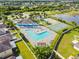 An aerial view showcasing a luxurious pool, a charming playground, and a well-maintained tennis court at 8105 Bilston Village Ln, Gibsonton, FL 33534
