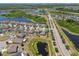 High aerial showcasing homes, a lake, and roadways in an expansive community at 8105 Bilston Village Ln, Gibsonton, FL 33534