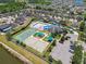 An aerial view showcasing the community's amenities, including a pool, playground, and tennis and basketball courts at 8105 Bilston Village Ln, Gibsonton, FL 33534