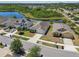 Aerial view of a residential street, featuring single-Gathering homes with private yards and community pond at 8105 Bilston Village Ln, Gibsonton, FL 33534