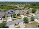 Neighborhood aerial showcasing houses near a pond, green spaces, and orderly street layouts at 8105 Bilston Village Ln, Gibsonton, FL 33534