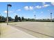 Community basketball court featuring hoops, lighting, concrete floor, and perimeter fencing at 8105 Bilston Village Ln, Gibsonton, FL 33534