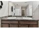 Bathroom featuring double sinks, granite countertop, and modern fixtures at 8105 Bilston Village Ln, Gibsonton, FL 33534