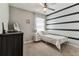 Cozy bedroom featuring stylish striped wall design and comfortable bed at 8105 Bilston Village Ln, Gibsonton, FL 33534