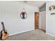 Bright bedroom features soft carpet, a round mirror, and doorway at 8105 Bilston Village Ln, Gibsonton, FL 33534