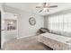 Comfortable bedroom featuring a ceiling fan, neutral walls, and cozy carpet flooring at 8105 Bilston Village Ln, Gibsonton, FL 33534