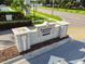 Community entrance sign for Carriage Pointe, with stone accents, set in well-maintained landscaping on a sunny day at 8105 Bilston Village Ln, Gibsonton, FL 33534