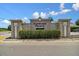 Community entrance sign for Carriage Pointe is surrounded by manicured landscaping on a sunny day at 8105 Bilston Village Ln, Gibsonton, FL 33534