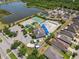 Aerial view of community amenities including a pool, tennis court, and green spaces at 8105 Bilston Village Ln, Gibsonton, FL 33534