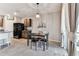 Open concept floor plan from kitchen to dining area with modern light fixture at 8105 Bilston Village Ln, Gibsonton, FL 33534