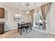 Dining room with slider to patio, neutral walls and flooring, and modern light fixture at 8105 Bilston Village Ln, Gibsonton, FL 33534