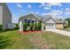 Single-story home with well-maintained lawn and landscaping at 8105 Bilston Village Ln, Gibsonton, FL 33534