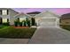 Charming single-story home featuring a two-car garage and well-manicured lawn at 8105 Bilston Village Ln, Gibsonton, FL 33534