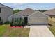 Well-maintained home showcasing a tidy front yard, neutral exterior, and attached two-car garage at 8105 Bilston Village Ln, Gibsonton, FL 33534