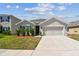 Charming single-story home featuring a two-car garage and well-manicured lawn at 8105 Bilston Village Ln, Gibsonton, FL 33534