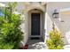 Front entry featuring a solid door and classic lighting at 8105 Bilston Village Ln, Gibsonton, FL 33534