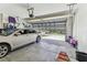 View of a two car garage with an open garage door and a silver car inside at 8105 Bilston Village Ln, Gibsonton, FL 33534