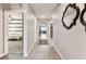 Hallway with decorative mirror and view of laundry and bedroom at 8105 Bilston Village Ln, Gibsonton, FL 33534