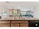 This eat-in kitchen features granite countertops and stainless steel appliances and is next to the dining and living room at 8105 Bilston Village Ln, Gibsonton, FL 33534