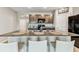 Modern kitchen features granite countertops, stainless steel appliances, and bar seating at 8105 Bilston Village Ln, Gibsonton, FL 33534