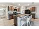 This kitchen features granite countertops, an island with seating, stainless steel appliances, and plenty of cabinets at 8105 Bilston Village Ln, Gibsonton, FL 33534