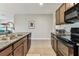 This kitchen features stainless steel appliances, granite countertops and brown cabinets at 8105 Bilston Village Ln, Gibsonton, FL 33534