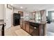 Open-concept kitchen with granite countertops, stainless steel appliances, and a view to the carpeted dining and living area at 8105 Bilston Village Ln, Gibsonton, FL 33534