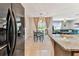 An eat-in kitchen featuring black appliances is next to a formal dining room and the living room at 8105 Bilston Village Ln, Gibsonton, FL 33534