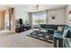Open concept living room features large sectional sofa and slider to screened patio at 8105 Bilston Village Ln, Gibsonton, FL 33534