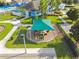 Aerial view of the playground, with sunshades over a modern jungle gym on a well-manicured lawn at 8105 Bilston Village Ln, Gibsonton, FL 33534