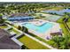 Aerial view of a community pool, tennis court, clubhouse and playground, perfect for Gathering fun and active living at 8105 Bilston Village Ln, Gibsonton, FL 33534