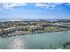 An impressive aerial view features waterfront condominiums, docks, swimming pools, and lush landscaping at 936 Pinellas Bayway S # T-5, Tierra Verde, FL 33715