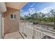 Balcony view showcasing a spacious driveway, garage and lush landscaping at 936 Pinellas Bayway S # T-5, Tierra Verde, FL 33715