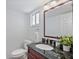 Modern bathroom with a granite countertop vanity and updated fixtures, offering a clean aesthetic at 936 Pinellas Bayway S # T-5, Tierra Verde, FL 33715