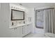 Bathroom featuring a double sink vanity, a large mirror, and a shower-tub combo at 936 Pinellas Bayway S # T-5, Tierra Verde, FL 33715