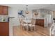 Dining room with a stylish table and views into the kitchen and living room at 936 Pinellas Bayway S # T-5, Tierra Verde, FL 33715
