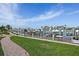 Scenic dock featuring boat slips, lush green landscaping, and waterfront views against a backdrop of clear skies at 936 Pinellas Bayway S # T-5, Tierra Verde, FL 33715