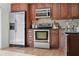 Modern kitchen features stainless steel appliances and sleek wood cabinetry at 936 Pinellas Bayway S # T-5, Tierra Verde, FL 33715