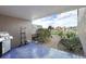 Outdoor patio area with a grill and a garden path with views of waterfront homes at 936 Pinellas Bayway S # T-5, Tierra Verde, FL 33715