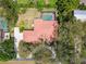 Expansive property featuring a clay tile roof, basketball court, mature trees and long private driveway at 9611 125Th N St, Seminole, FL 33772