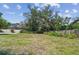 The expansive lawn boasts a privacy fence, mature trees, and landscaping, providing a serene outdoor space at 9611 125Th N St, Seminole, FL 33772