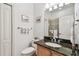 Bathroom featuring wood cabinets, granite counters, and tiled walk-in shower at 9611 125Th N St, Seminole, FL 33772