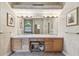 Bathroom featuring double sinks, large mirror, and neutral decor at 9611 125Th N St, Seminole, FL 33772