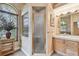 Well-lit bathroom with glass shower, arched window, and ample counter space at 9611 125Th N St, Seminole, FL 33772