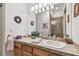 Bathroom with warm wood cabinets, granite counters, and tiled walk-in shower at 9611 125Th N St, Seminole, FL 33772