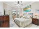 Cozy bedroom featuring a wrought iron bed frame, plush bedding, and bright natural light from bay windows at 9611 125Th N St, Seminole, FL 33772