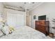 Bedroom featuring white closet doors, decor and a wooden dresser with TV at 9611 125Th N St, Seminole, FL 33772