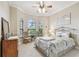 Bedroom features bay windows, a wrought iron bed frame and wooden dresser at 9611 125Th N St, Seminole, FL 33772