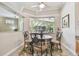 Charming breakfast nook with a round table, wrought iron chairs, and a view of the screened-in pool area at 9611 125Th N St, Seminole, FL 33772